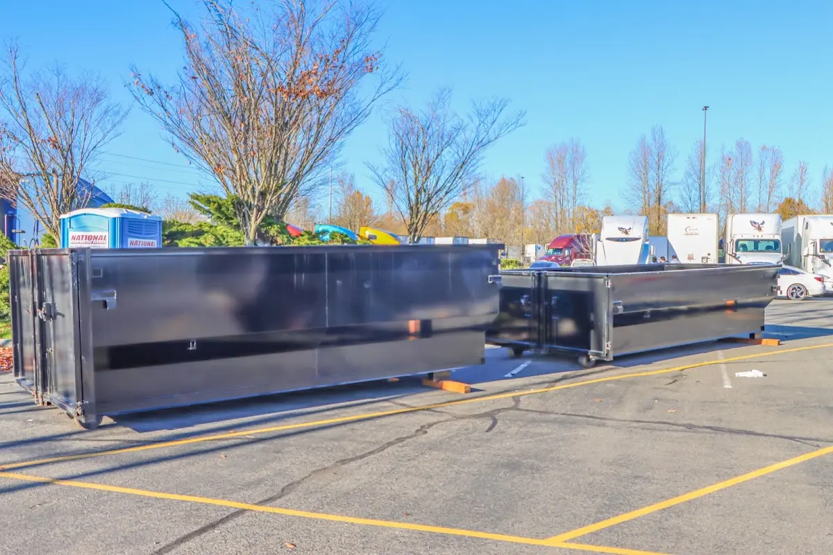 Professional dumpster rental service with roll-off container on residential driveway in Southern Pines